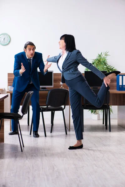 Two employees doing sport exercises in the office