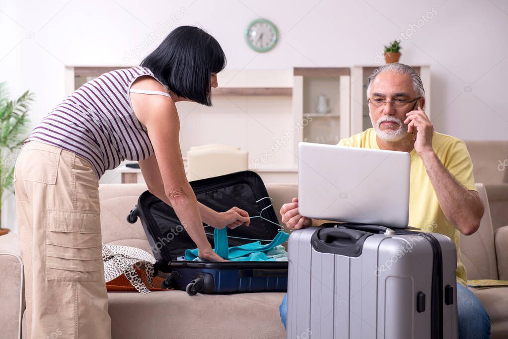 Old couple preparing for vacation travel