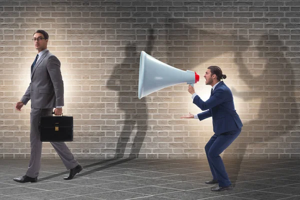 Businessman shouting through large loudspeaker — Stock Photo, Image