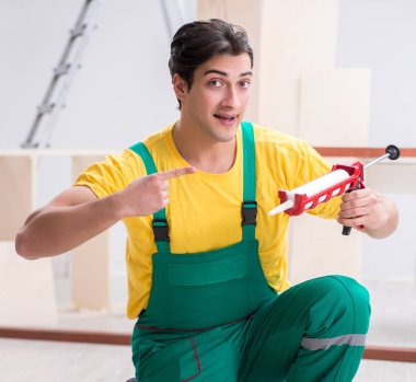 Müteahhit lamine ahşap zemin üzerinde çalışıyor.