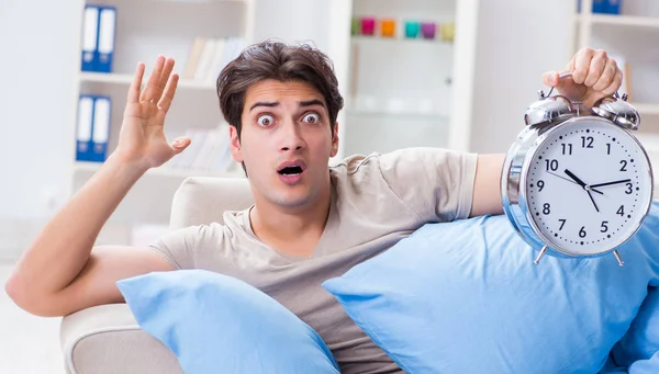 The man having trouble waking up with alarm clock — Stock Photo, Image