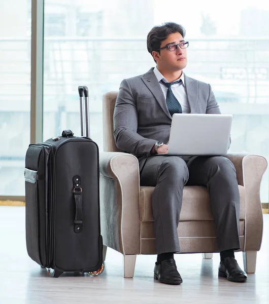 Young businessman in airport business lounge waiting for flight