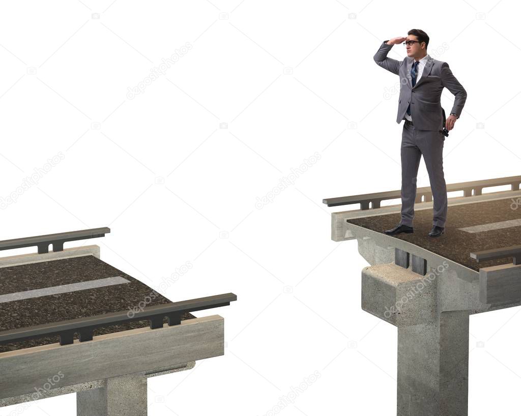 Young businessman with broken bridge isolated on white