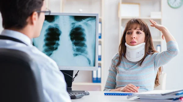 The young woman visiting radiologist for x-ray exam — Stock Image The young woman visiting radiologist for x-ray exam Royalty Free Stock Images