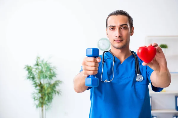 Young male doctor in sport and dieting concept