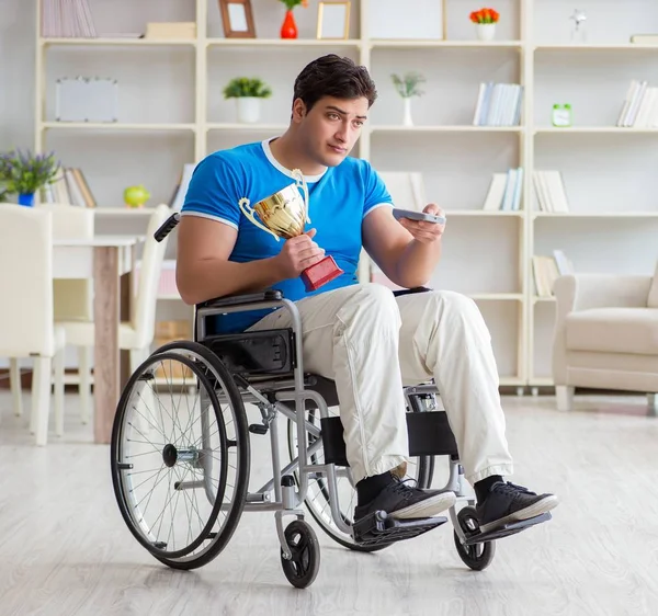 Disabled man watching sports on tv — Stock Photo, Image