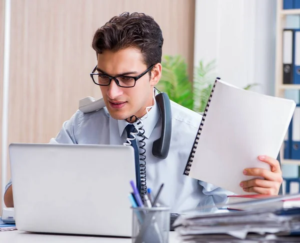 Young businessman under pressure in office to deliver tasks