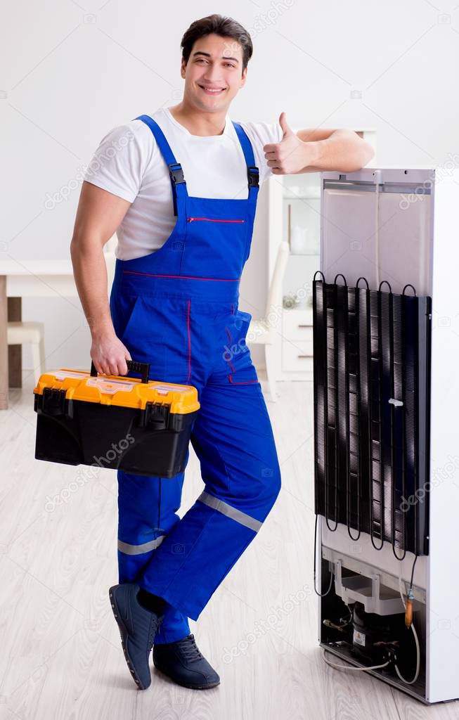 Repairman contractor repairing fridge in DIY concept