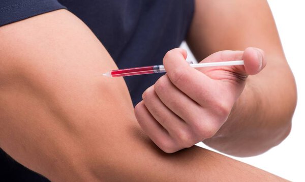 Young man in doping concept isolated on white