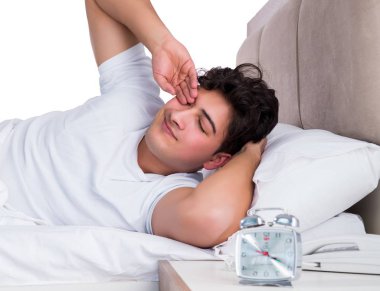 Yatakta uykusuzluk çeken bir adam.