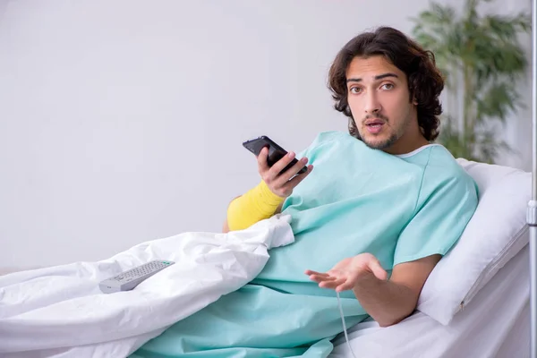 Young man staying in hospital in transfusion concept — Stock Photo, Image