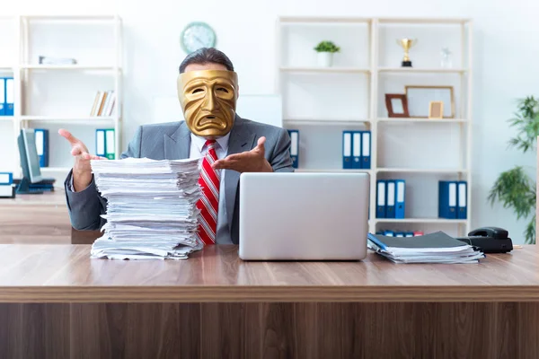 Businessman wearing mask in hypocrisy concept — Stock Photo, Image