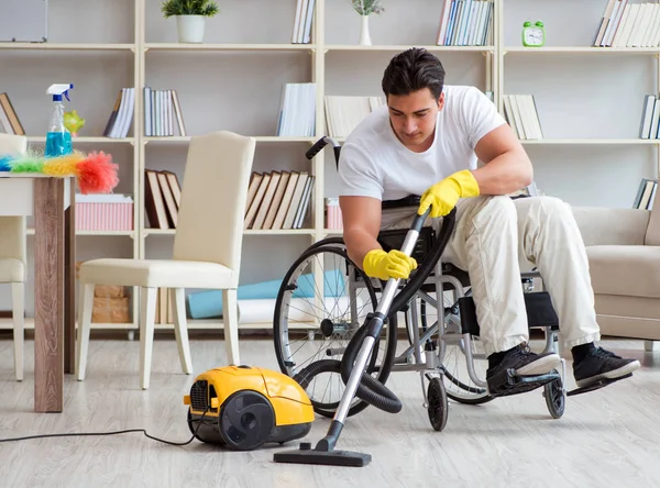 Disabled man with vacuum cleaner at home — Stock Photo, Image