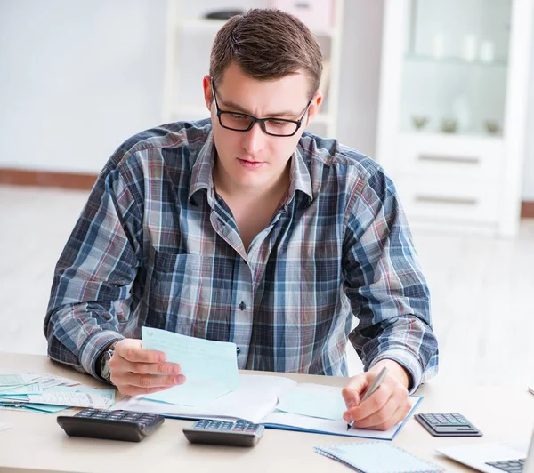 Young man frustrated at his house and tax bills — Stock Photo, Image