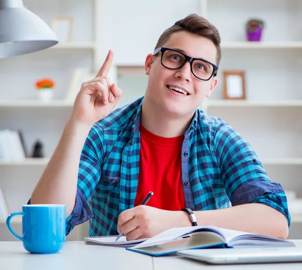 Junger Teenager bereitet sich am Schreibtisch im Haus auf Prüfungen vor — Stockfoto