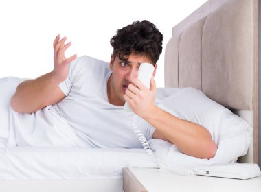 Yatakta uykusuzluk çeken bir adam.
