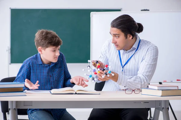Jonge mannelijke leraar uitleggen moleculair model — Stockfoto