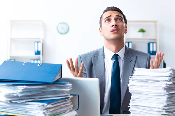 Businessman with heavy paperwork workload