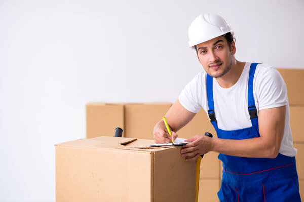 Young male professional mover doing home relocation