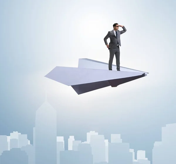 Businessman flying on paper plane in business concept — Stock Photo, Image