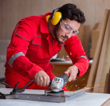 Öğütücü tekerlekle çalışan genç bir tamirci