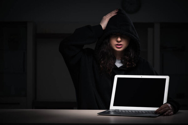 Female hacker hacking security firewall late in office