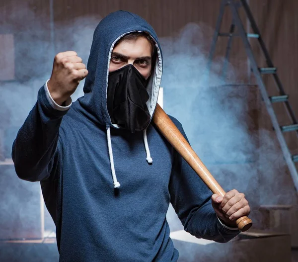 Hooligan with bat in dark room — Stock Photo, Image