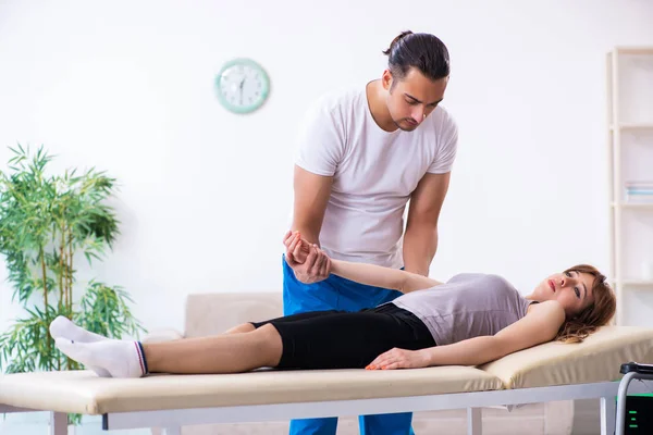 Young woman visiting male doctor physiotherapist — Stock Photo, Image