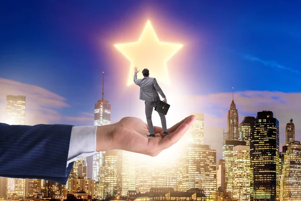 Businessman held on hand reaching out for stars — Stock Photo, Image