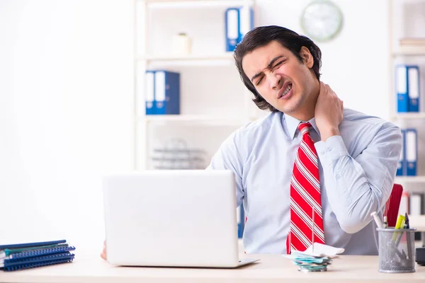 Young male employee suffering in the office — Stock Photo, Image