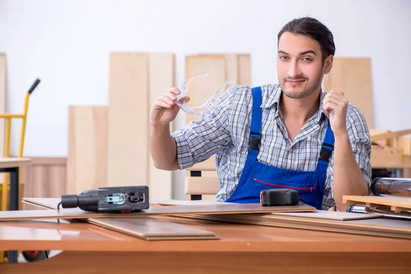Jovem carpinteiro do sexo masculino trabalhando dentro de casa — Fotografia de Stock