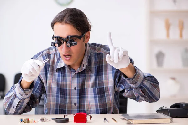 Jonge mannelijke juwelier in werkplaats — Stockfoto