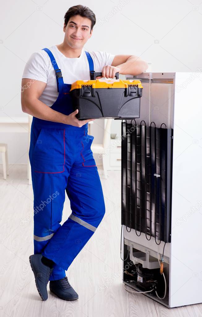 Repairman contractor repairing fridge in DIY concept