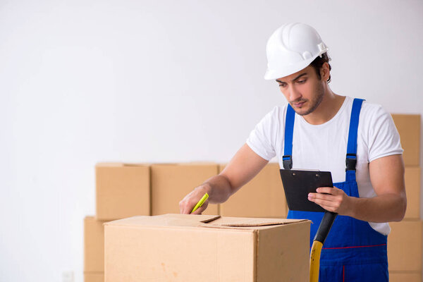 Young male professional mover doing home relocation