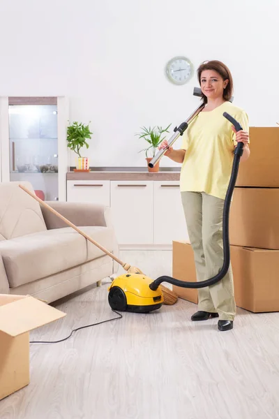 Wanita paruh baya membersihkan apartemen baru — Stok Foto