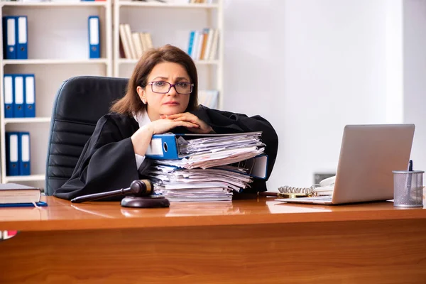 Middle-aged female doctor working in courthouse