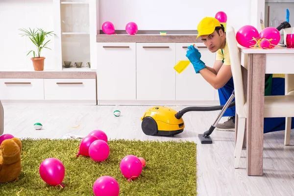 Young male contractor doing housework after party — Stock Photo, Image