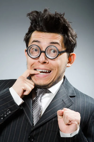 Funny nerd businessman in dark studio — Stock Photo, Image