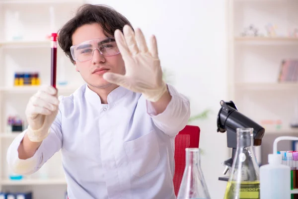 Bioquímico varón joven trabajando en el laboratorio — Foto de Stock