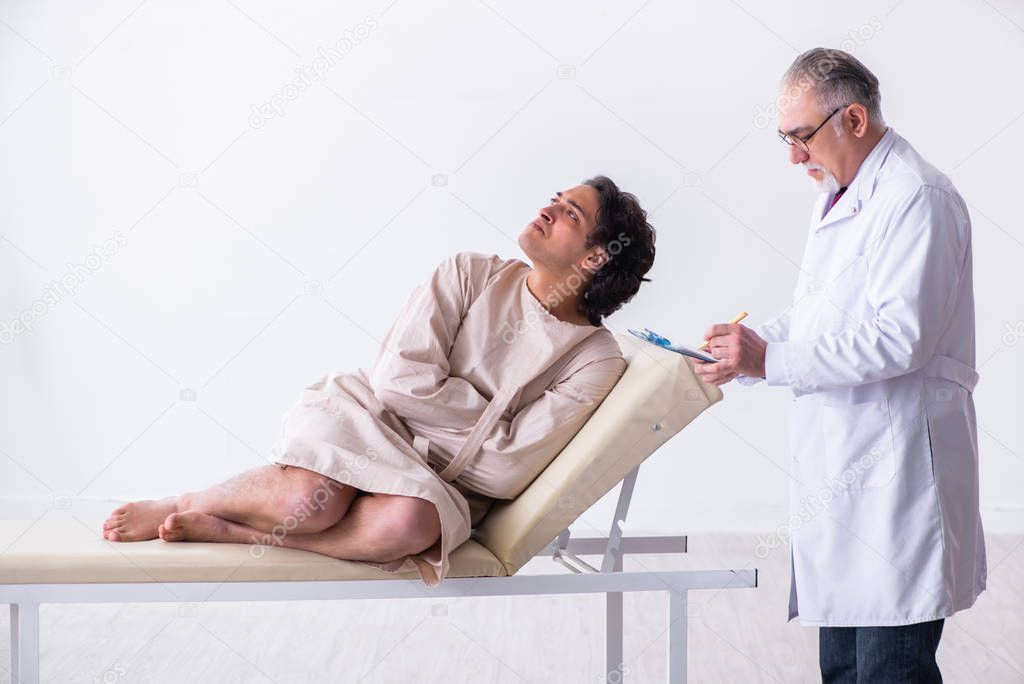 Aged male doctor psychiatrist examining young patient