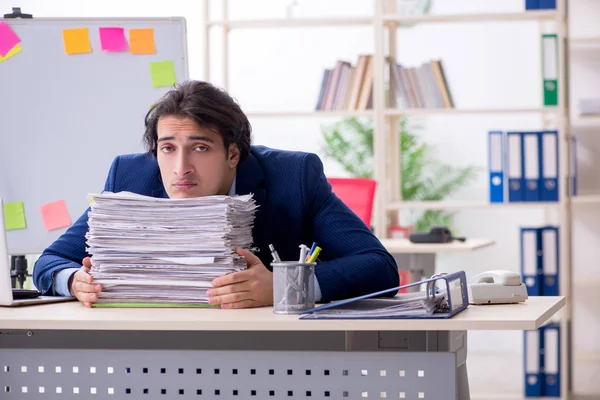 Young male employee unhappy with excessive work — Stock Photo, Image