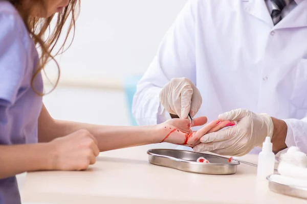 Mão ferida mulher visitante médico masculino — Fotografia de Stock