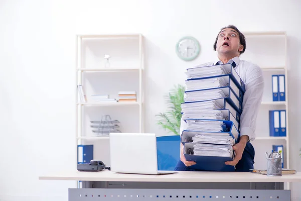 Joven empleado masculino infeliz con el trabajo excesivo —  Fotos de Stock