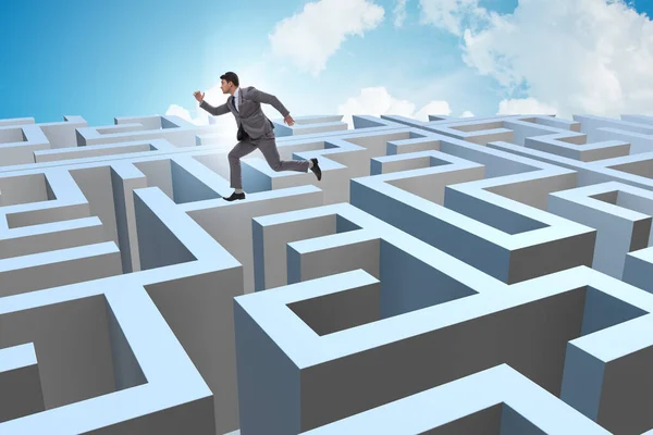 Businessman trying to escape from maze — Stock Photo, Image