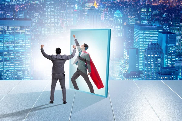 Businessman seeing himself in mirror as superhero