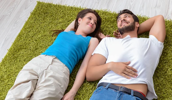 Familia joven desempacando en casa nueva con cajas — Foto de Stock