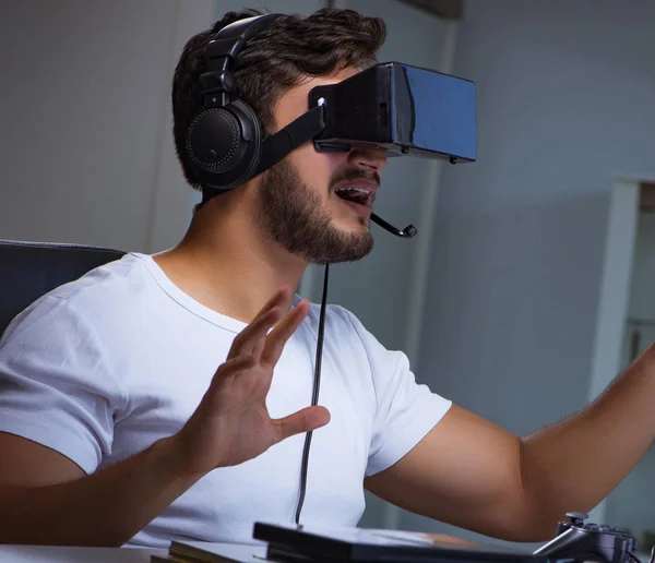 Young man playing games long hours late in the office — Stock Photo, Image