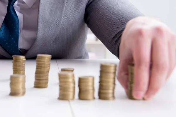 Businessman with golden coins in business growth concept — Stock Photo, Image