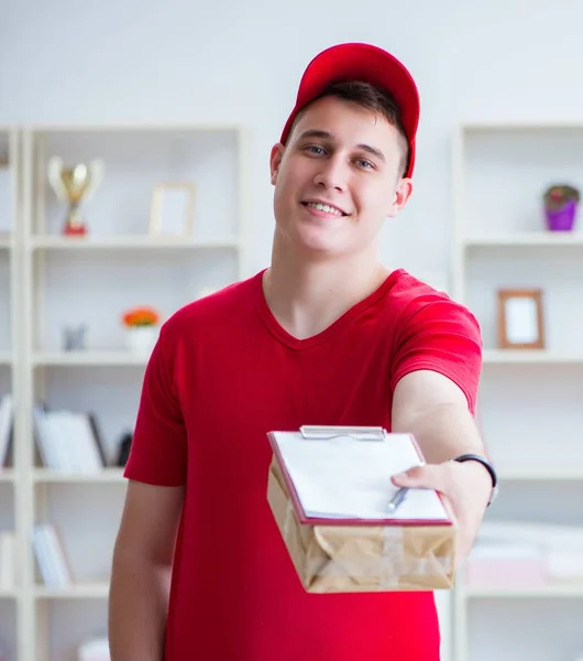 Post man leverera ett paket paket — Stockfoto