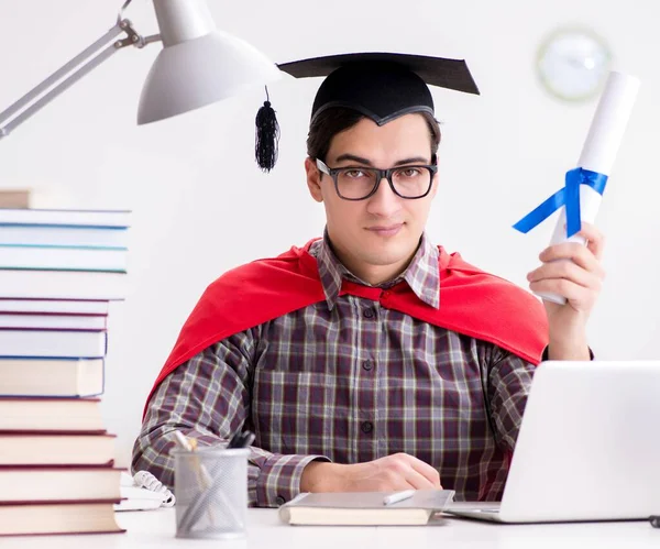 Super hero student wearing a mortarboard studying — Stock Photo, Image